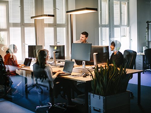 Team of people putting their hands together to collaborate — UCaaS integration